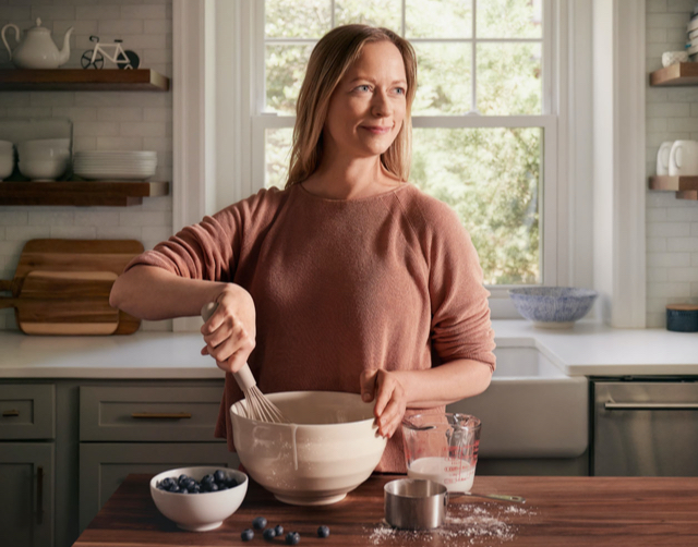 Hero woman standing in kitchen